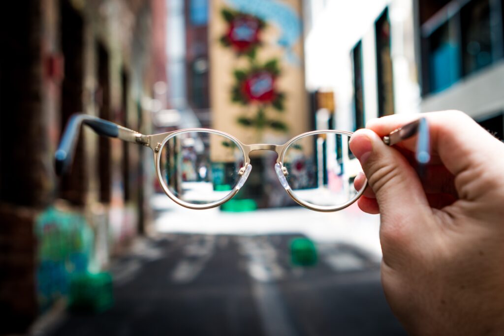 Person looking through glasses that helps to see world more clearly