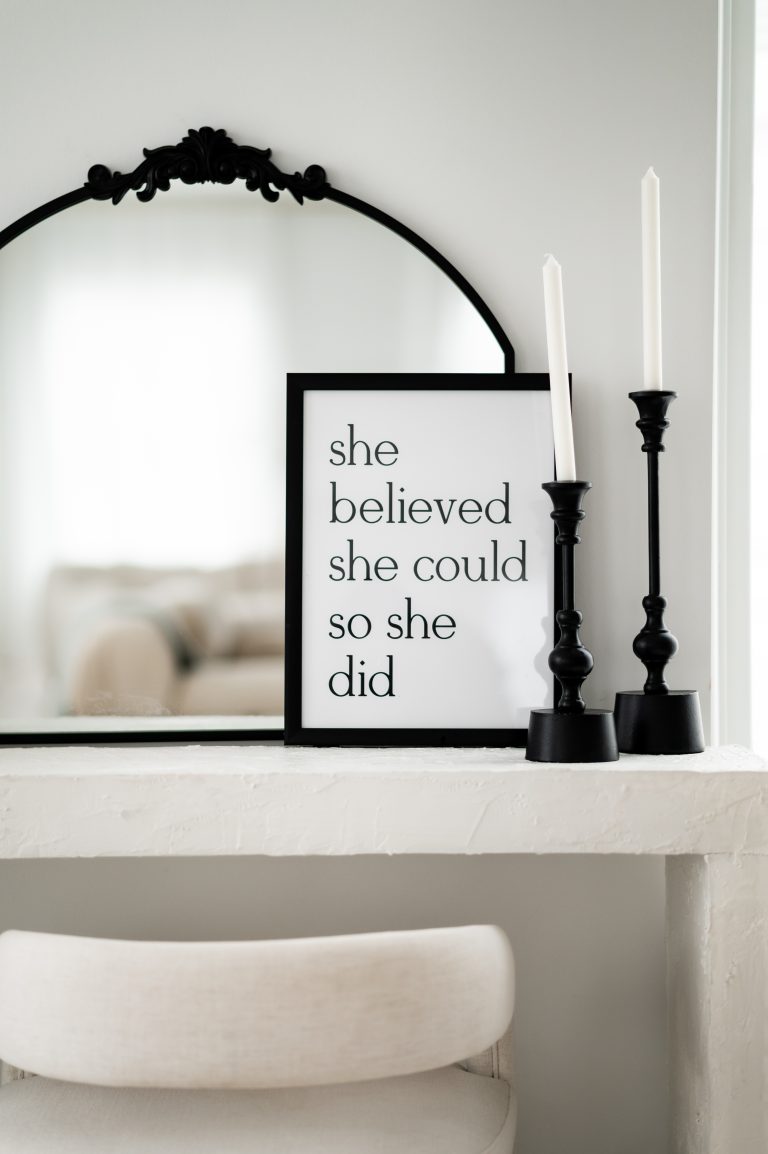 "she believed she could so she did" sign in wooded frame