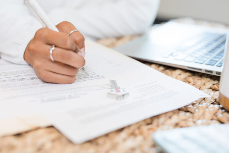 Black woman hand writing in notebook