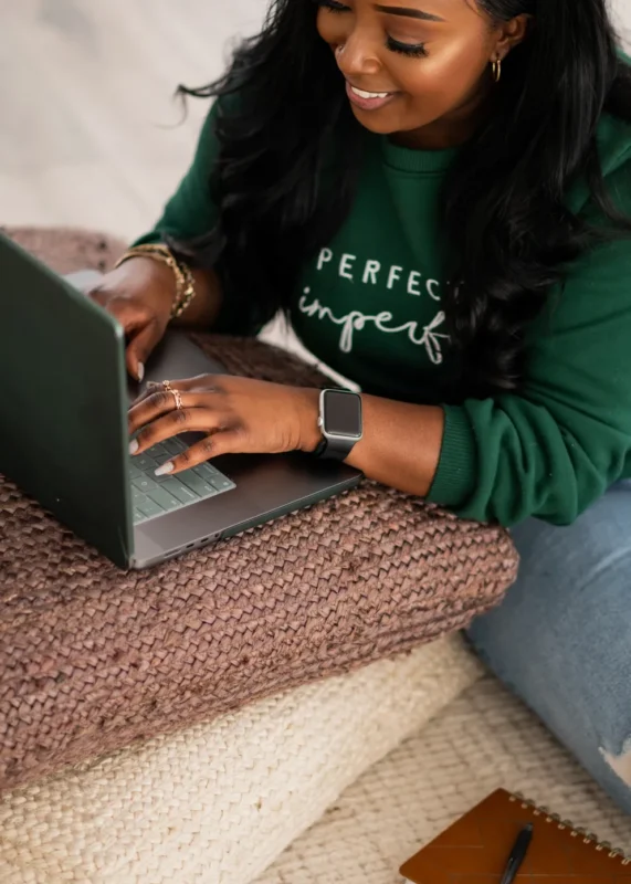 Successful Black woman with ADHD working on a laptop, symbolizing achievement while managing ADHD challenges.